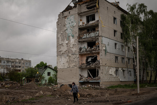 A resident walking past a damaged apartment block in the town of Borodyanka, Ukraine, on Sunday.
