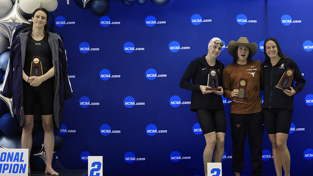 Transgender woman Lia Thomas (L) of the University of Pennsylvania stands on the podium after winning the 500-yard freestyle as other medalists (L-R) Emma Weyant, Erica Sullivan and Brooke Forde pose for a photo at the NCAA Division I Women