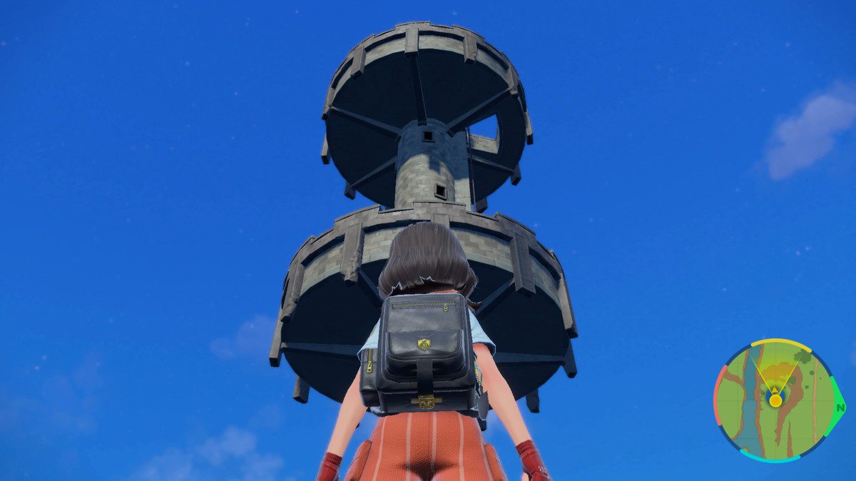 Un entrenador de Pokémon se para frente a una enorme torre de vigilancia.
