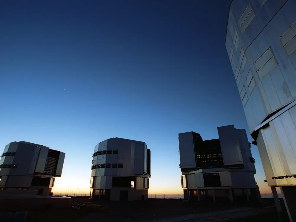 Cuatro grandes telescopios bajo el cielo nocturno