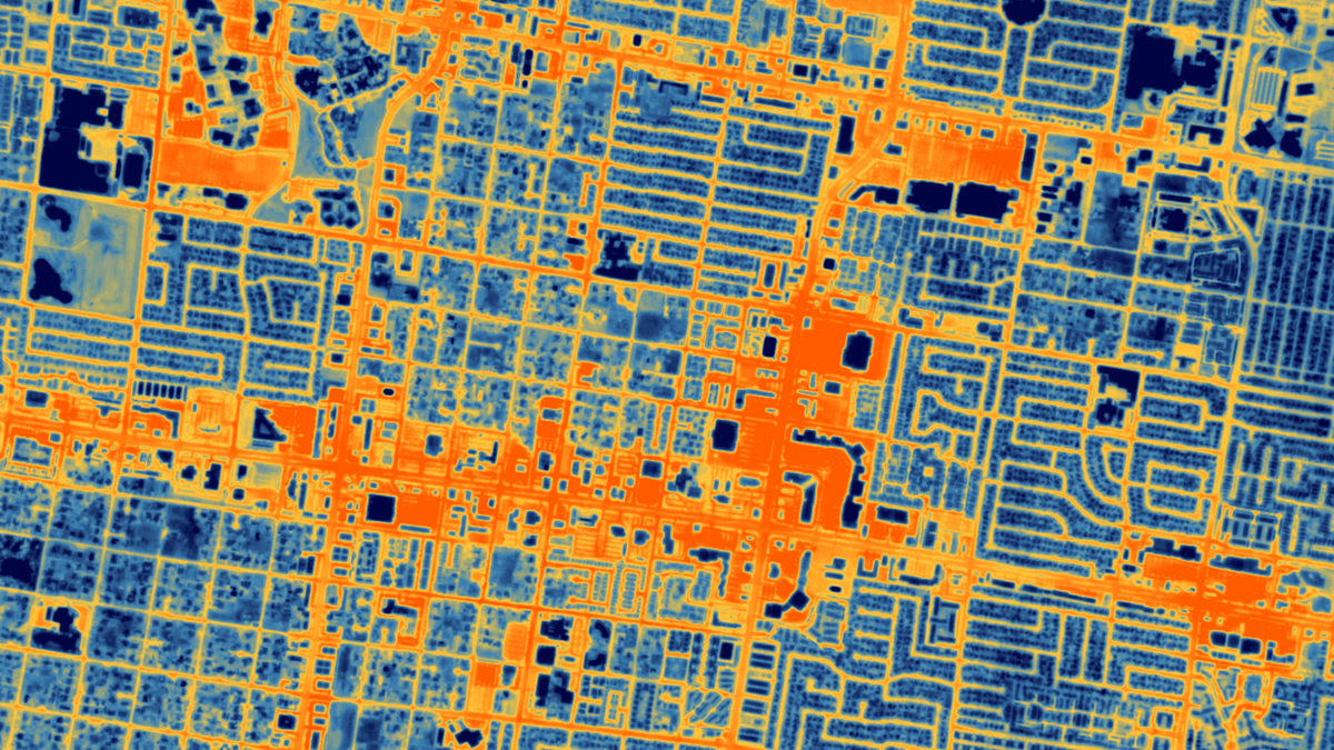 a thermal image of blue and orange shows the gridded streets of a city